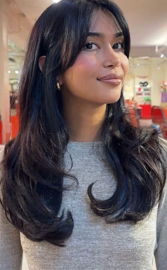 Layered black butterfly haircut with long curved pieces
