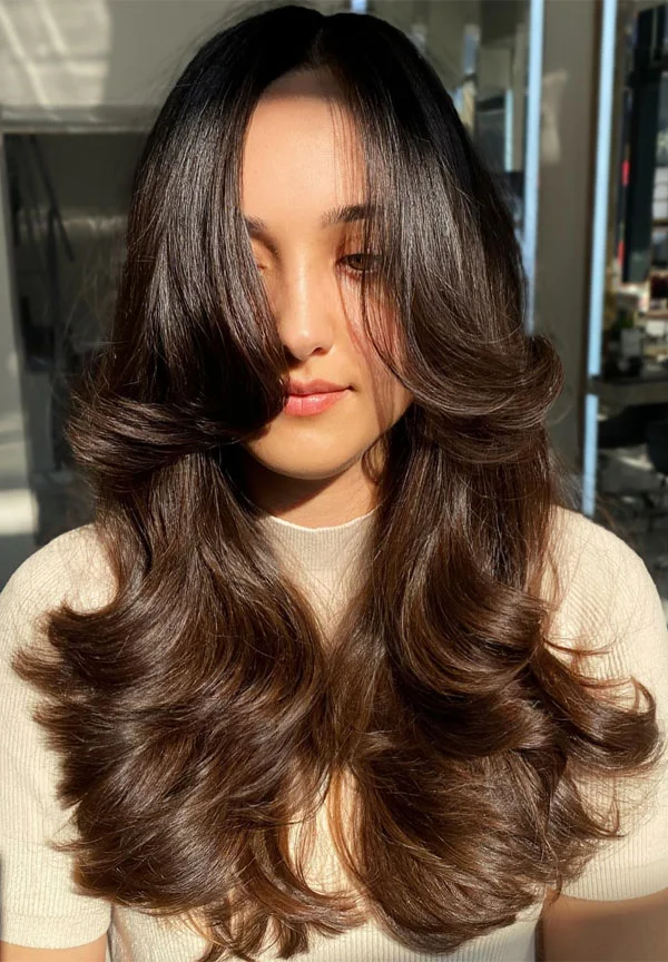 Chocolate brown butterfly haircut with long bouncy waves