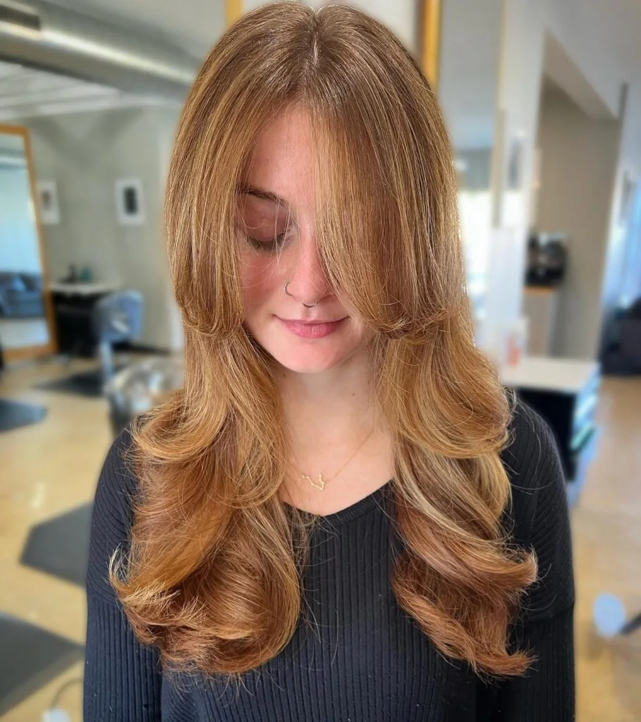 Copper blonde long butterfly haircut with curled ends