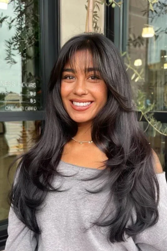 Soft black butterfly haircut with long blowout layers