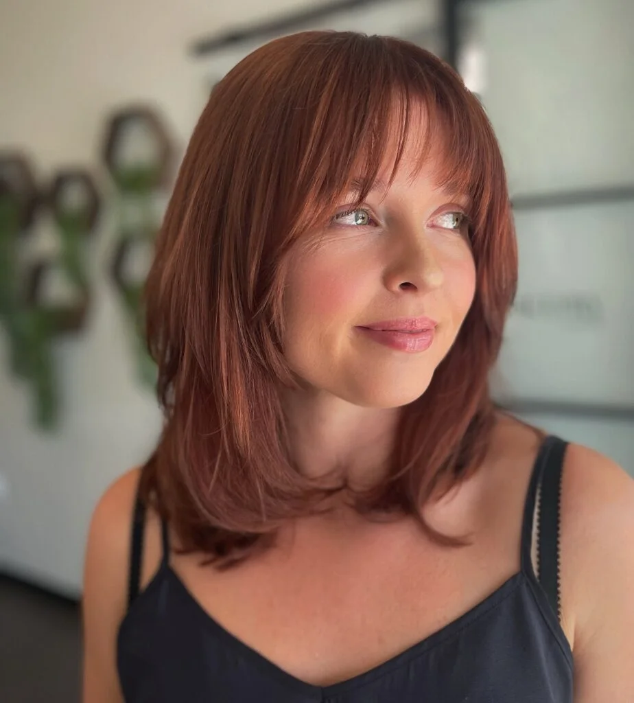 Auburn butterfly haircut with long face-framing layers