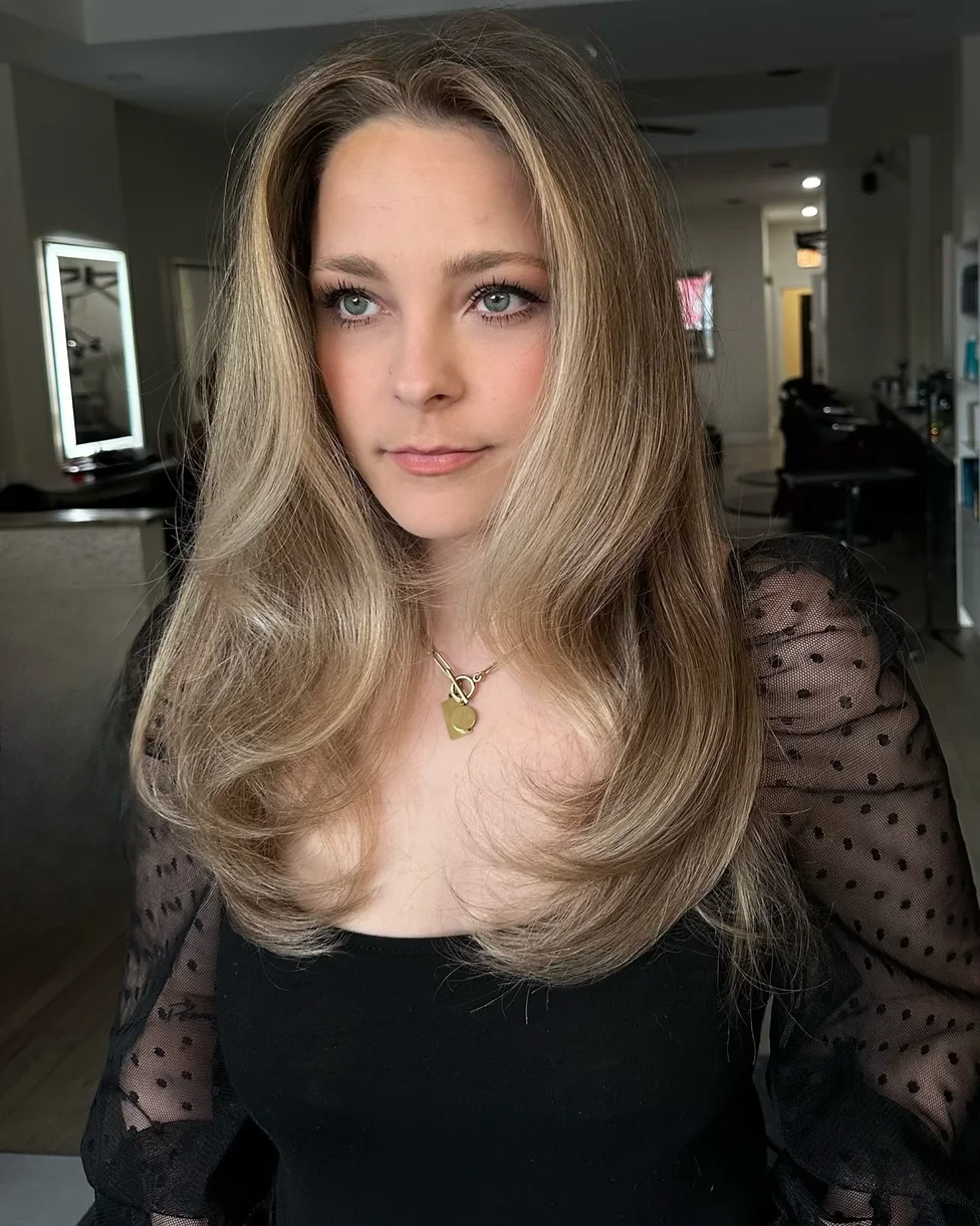 Soft blonde long butterfly haircut with airy layered shape
