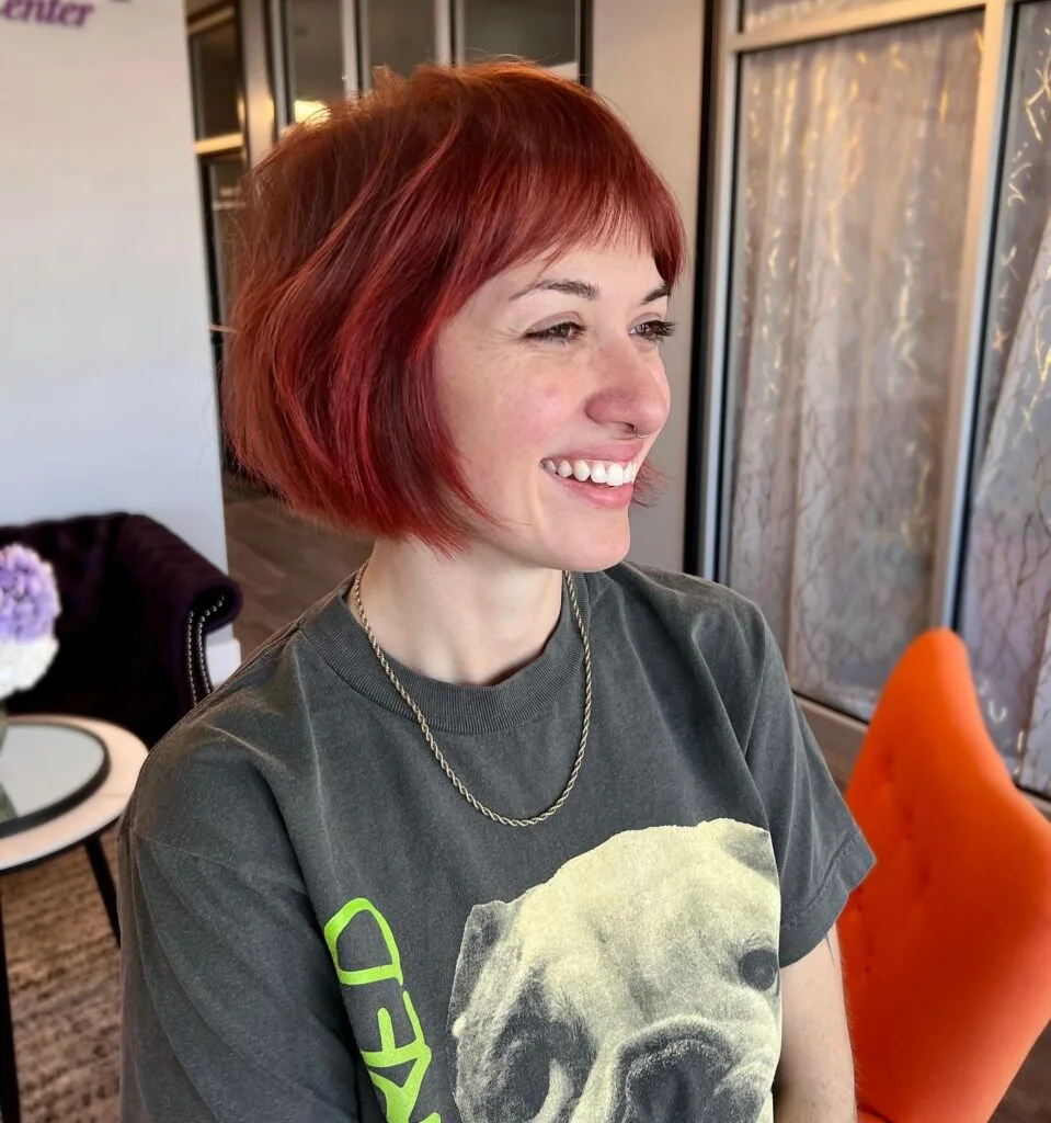 Red side-swept choppy bob for fine hair with jaw-length texture