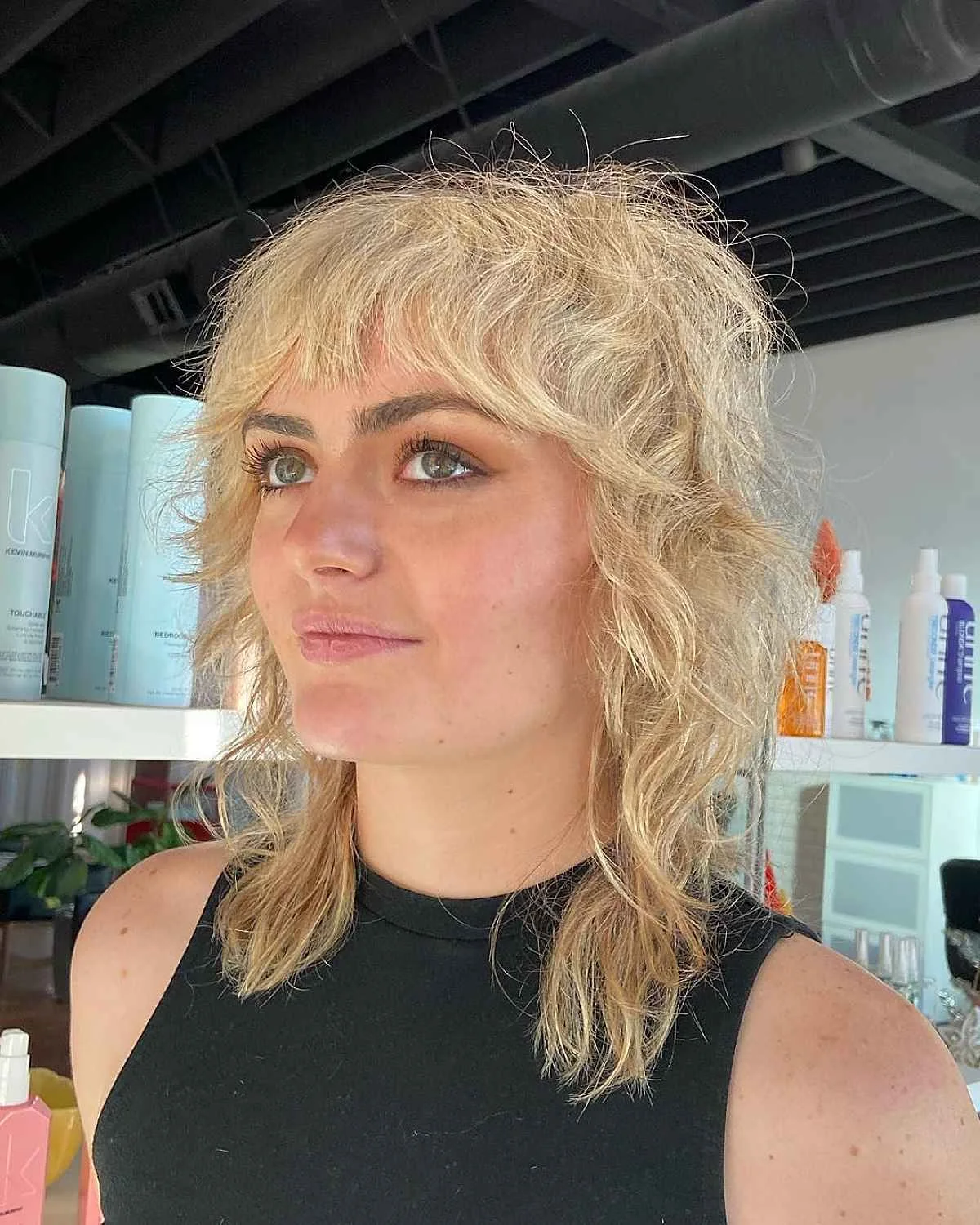 Blonde choppy shag bob for fine hair with curtain bangs and messy waves
