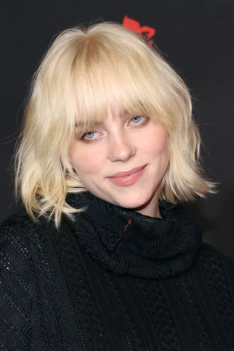 Blonde choppy bob for fine hair with curtain bangs and soft tousled ends