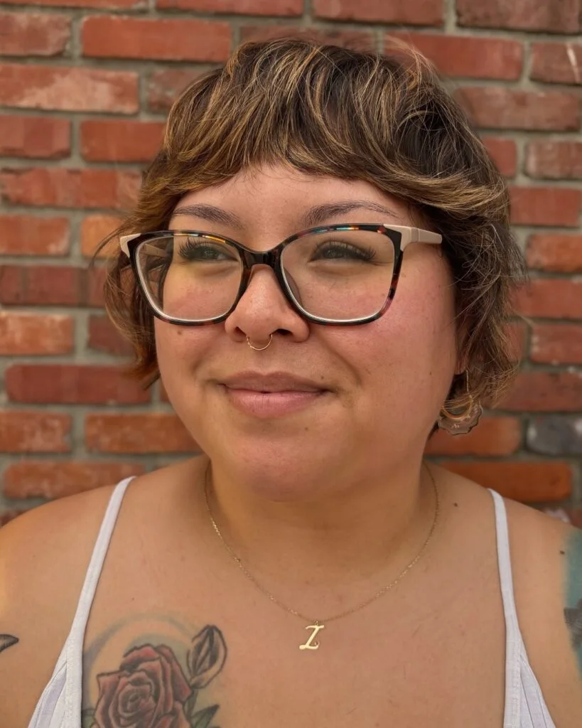 Wavy short choppy bob for fine hair with wispy bangs and glasses