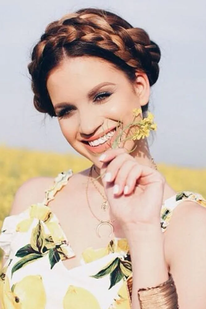 Brown hair wrapped into a raised braided crown across the forehead