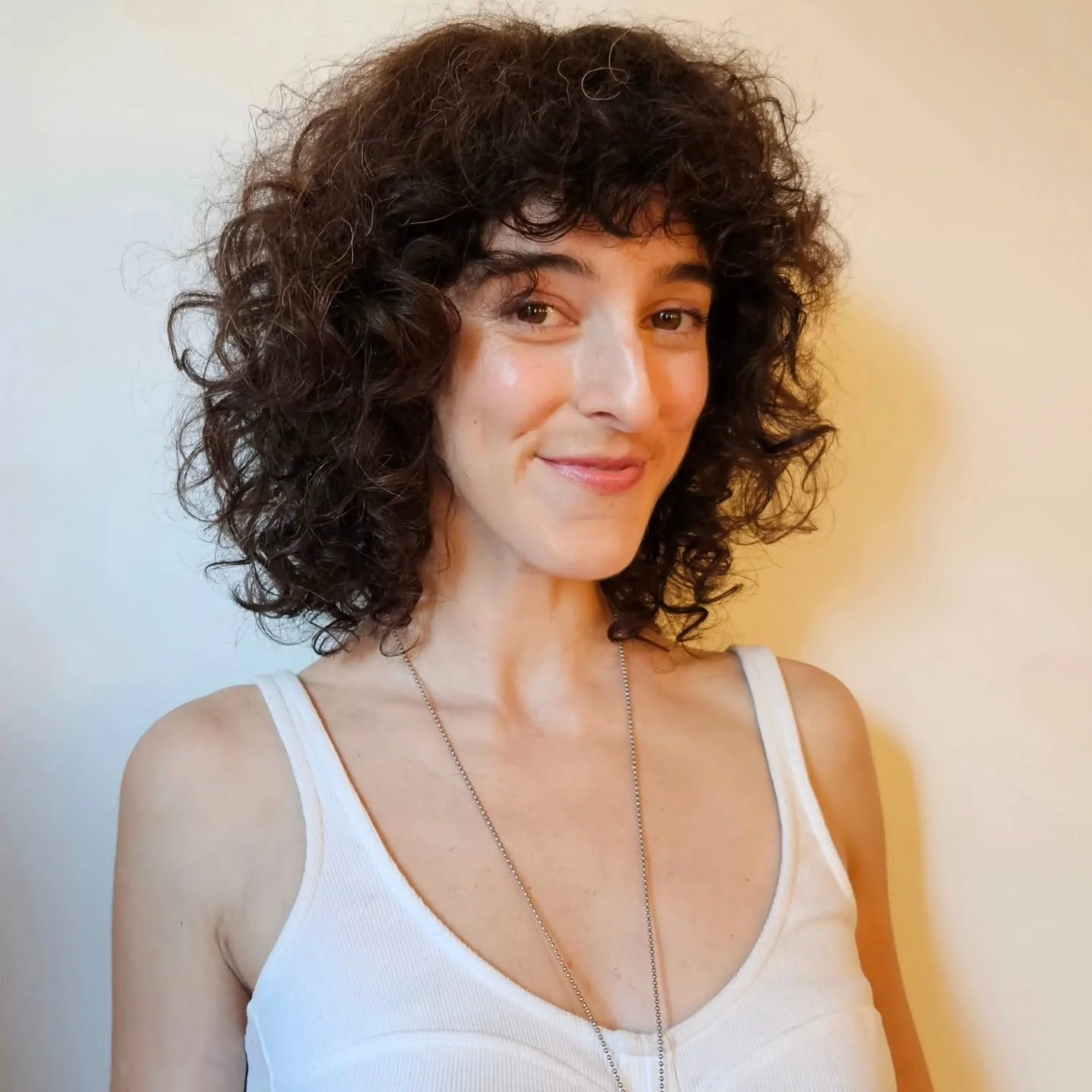 shoulder curly brunette shag with curly fringe fringe shown as a curly hairstyles ideas idea, featuring curly texture, shown in soft medium curls with round shape
