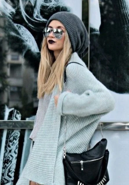 Loose straight hair under a grey beanie.
