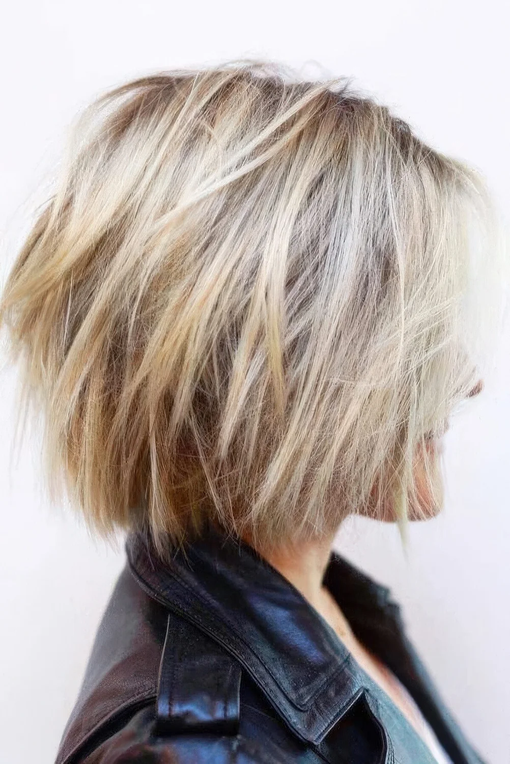 Blonde feathered bob with layers and balayage.