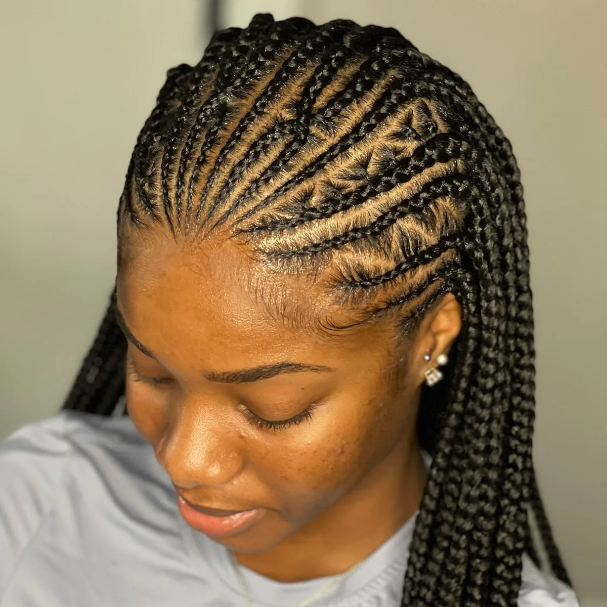 waist braids black knotless shown as a fulani braids idea, featuring braids texture, shown in black woman cornrow ponytail