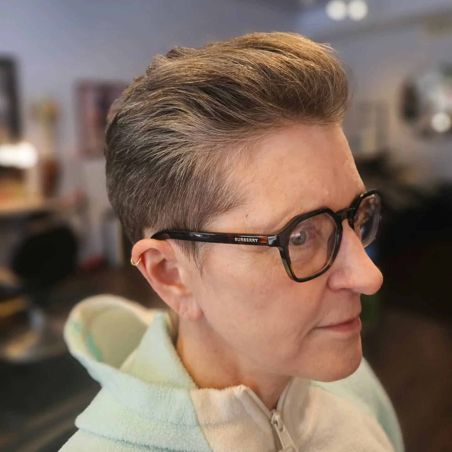 ear straight blonde pixie with side swept fringe shown as a gray blending for older women idea