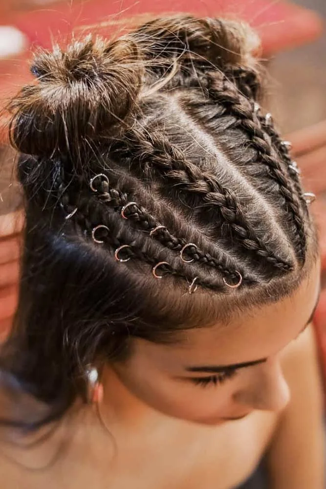 Top-side view of dark hair with two mini buns and small ringed scalp braids