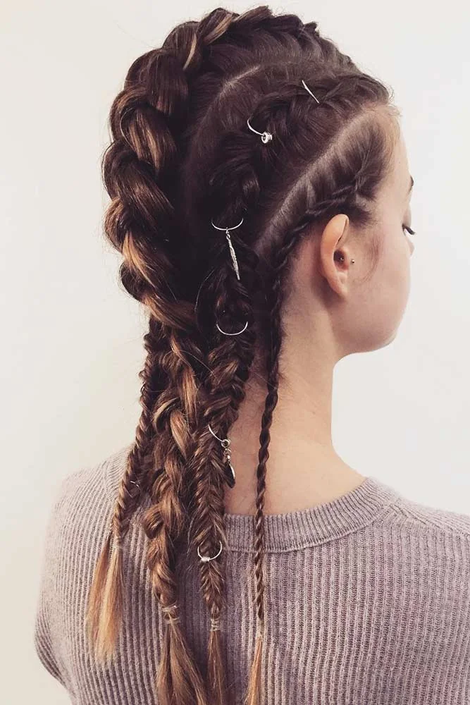 Back-side view of long brown hair in parallel raised braids with scattered small silver rings