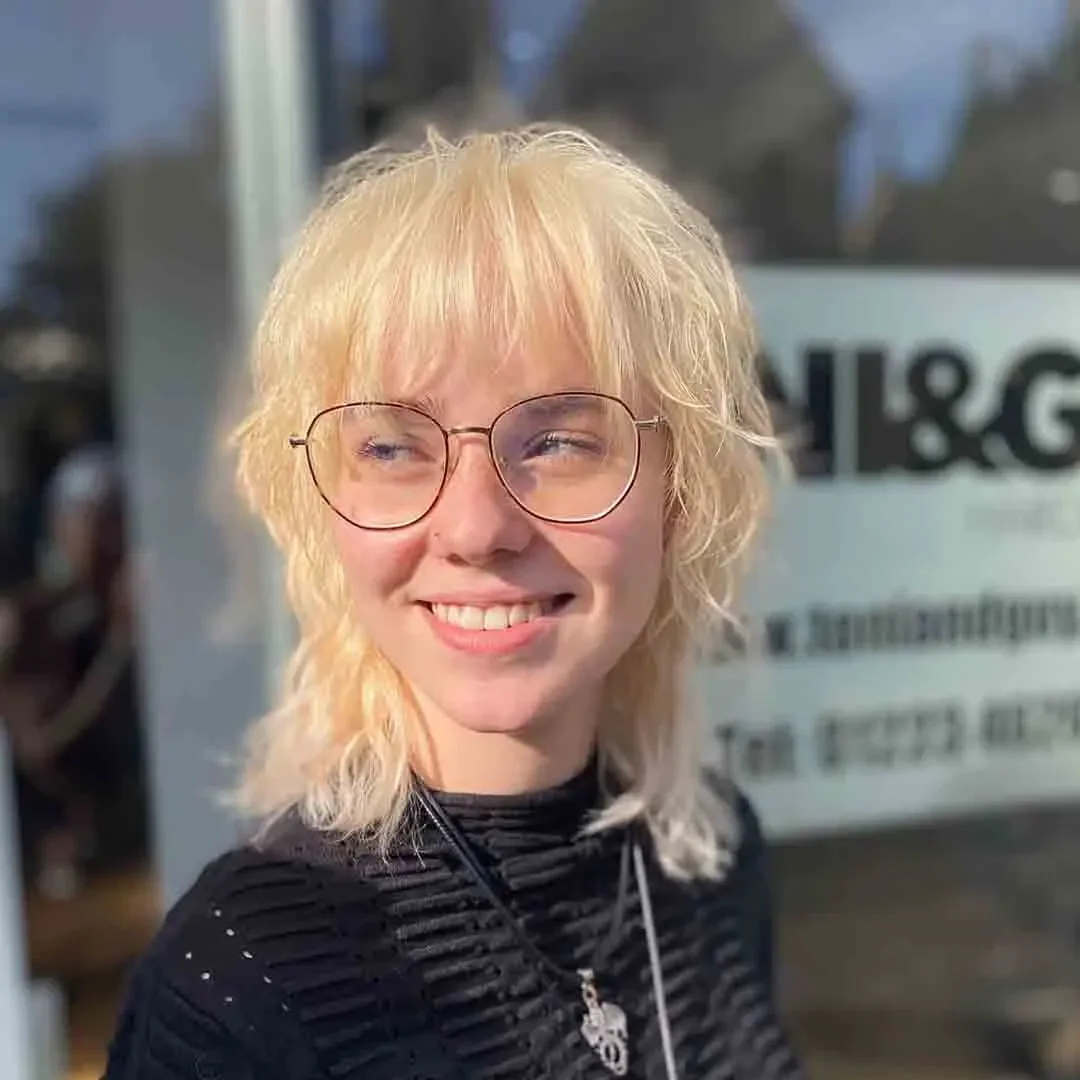 wispy blonde bob with glasses showing blonde bob hair with straight texture for thin fine hair