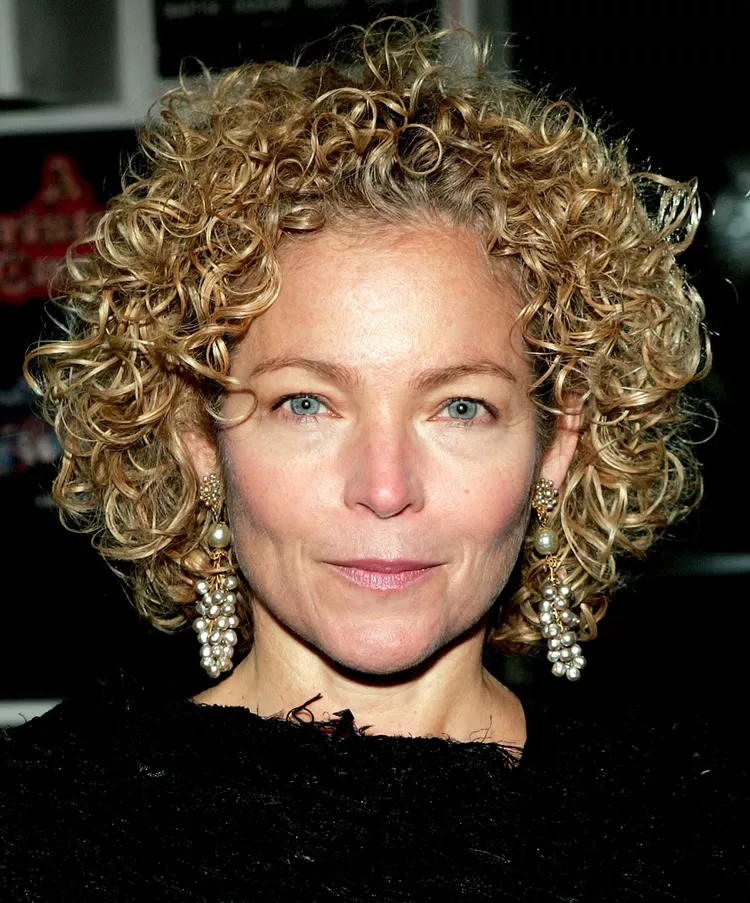 ear curly chestnut curly bob with curly fringe fringe shown as a haircuts for women over 50 idea