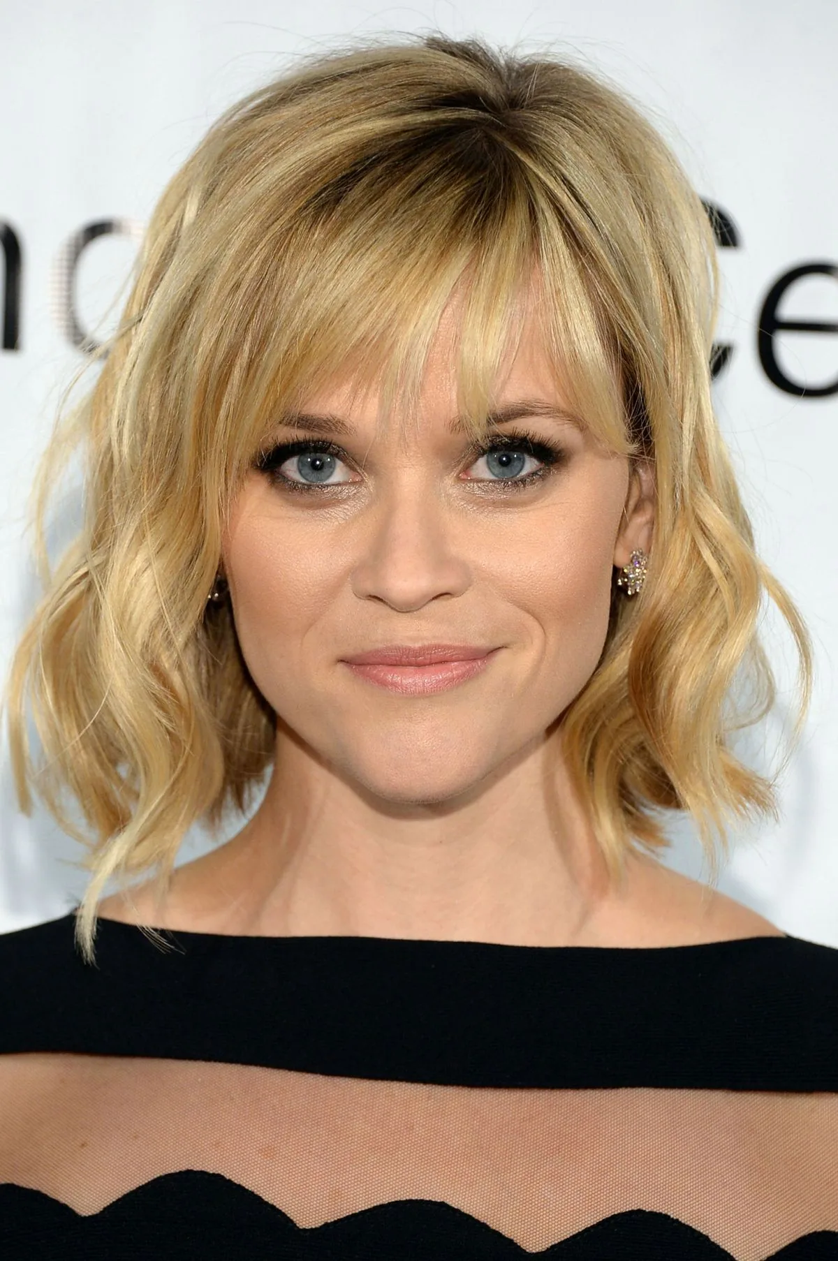 Blonde shoulder shag with wispy bangs and wavy textured layers