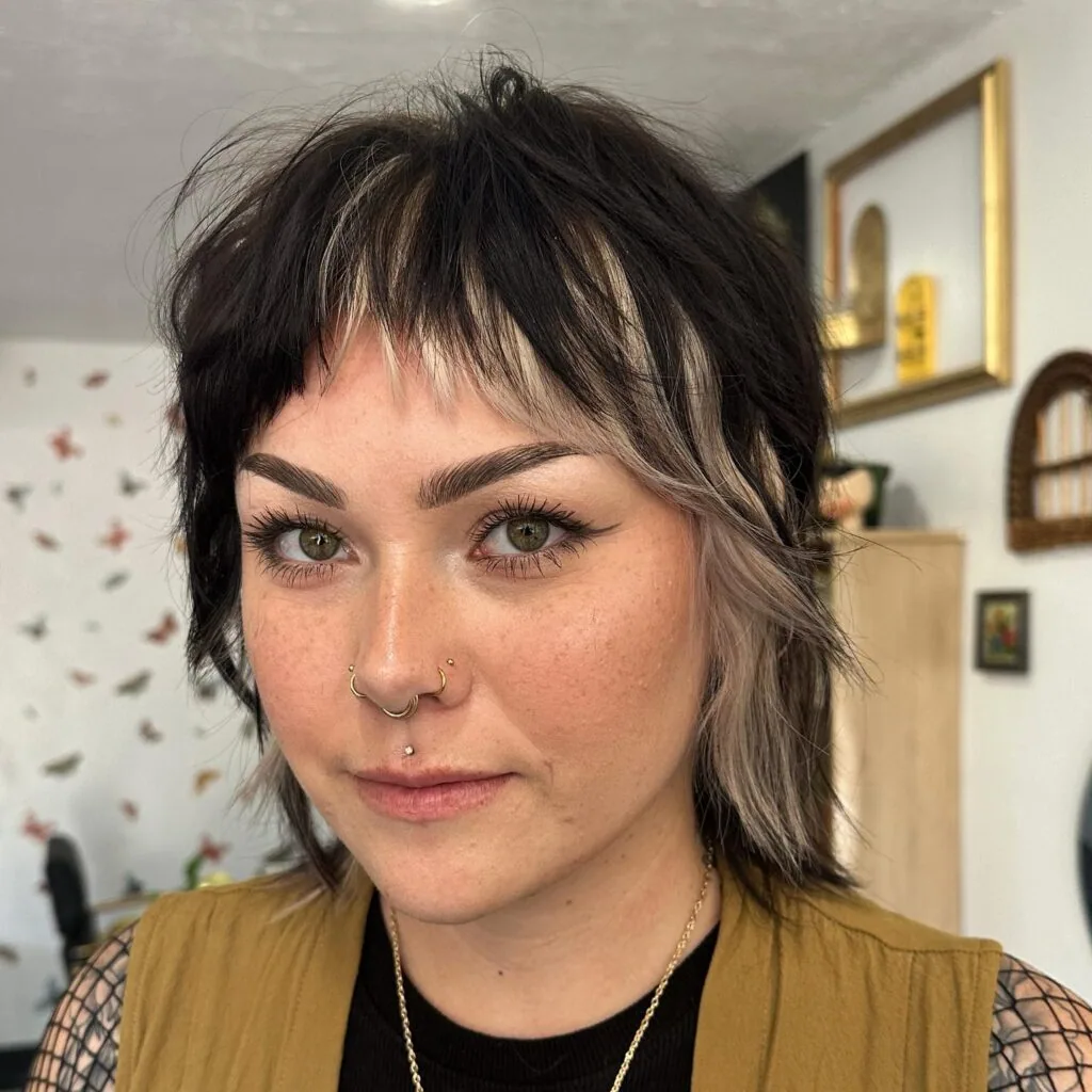 Choppy medium shag with short bangs and textured dark layers