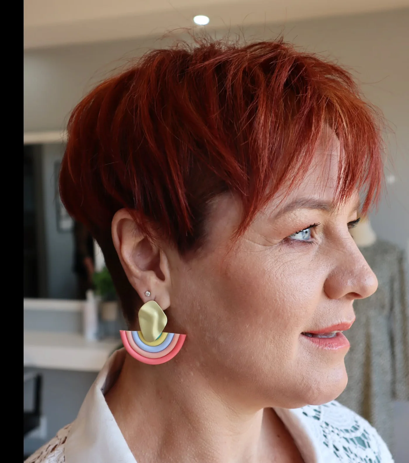 A feathered brunette pixie with airy short layers and light movement around the forehead. This hairstyle is shown as inspiration for women over 60 with thin hair.