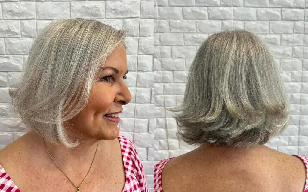 A tousled silver bob with gentle bends, airy sides, and soft movement around the face. This hairstyle is shown as inspiration for women over 60 with thin hair.
