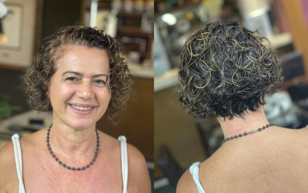 A short curly gray crop with rounded curl shape and soft volume at the sides. This hairstyle is shown as inspiration for women over 60 with thin hair.
