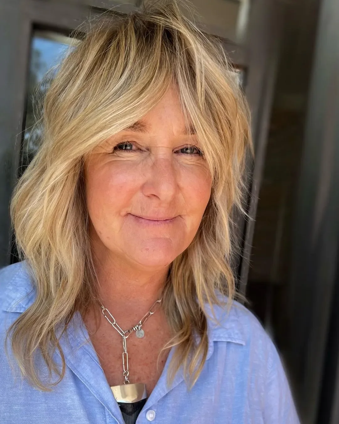 Blonde shag with curtain bangs and shoulder-length waves