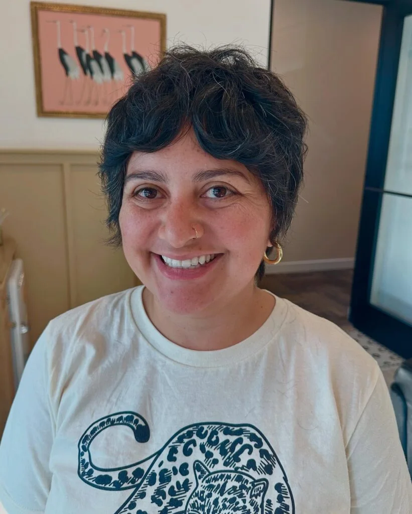 Short natural pixie with soft bangs on a mature woman