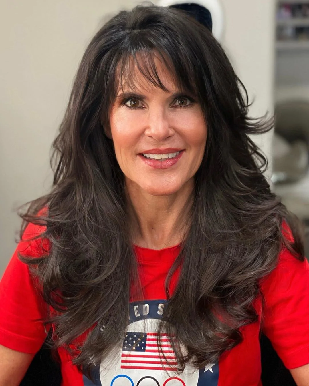 Black layered hairstyle with curtain bangs on an older woman