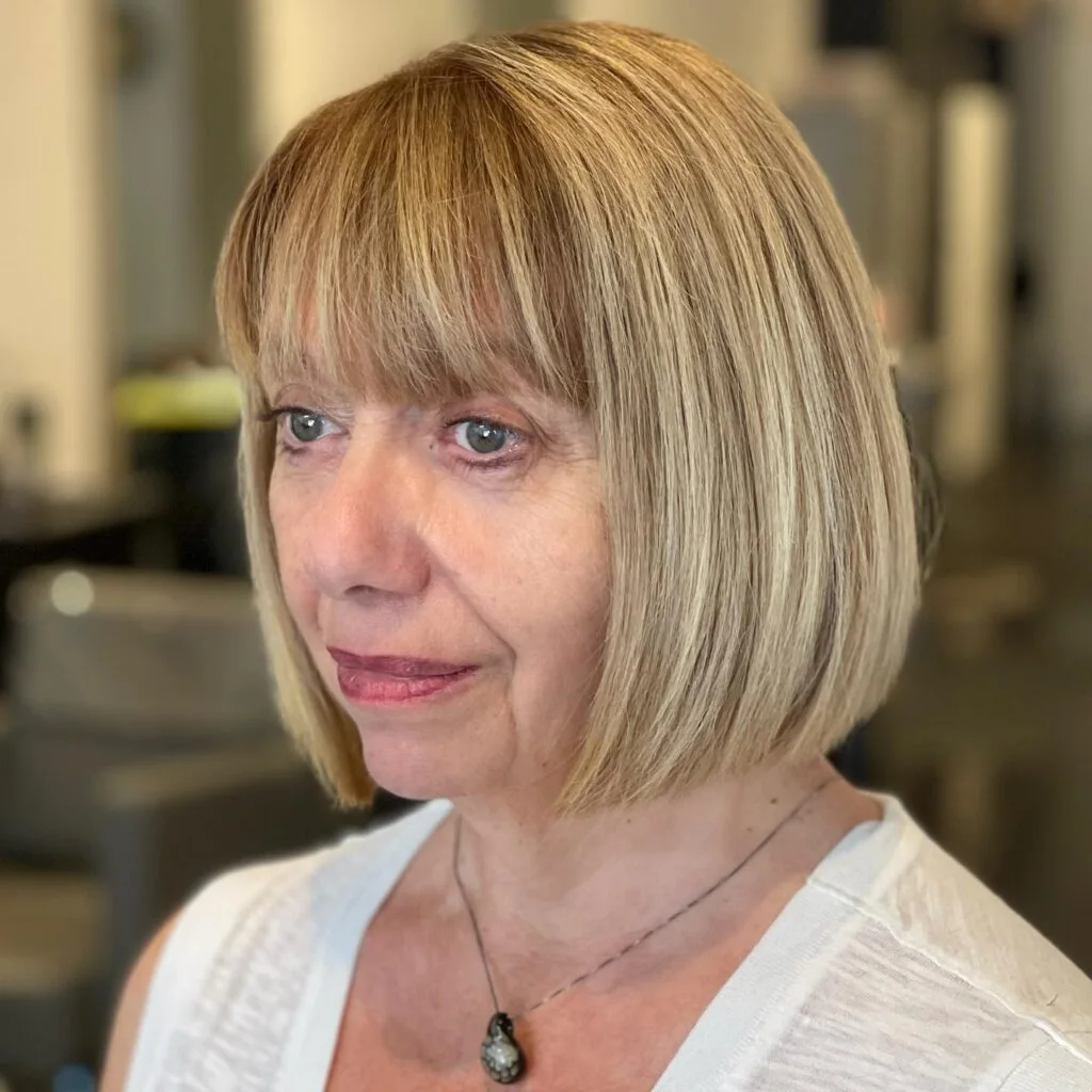 Blonde chin bob with fine bangs and a rounded shape