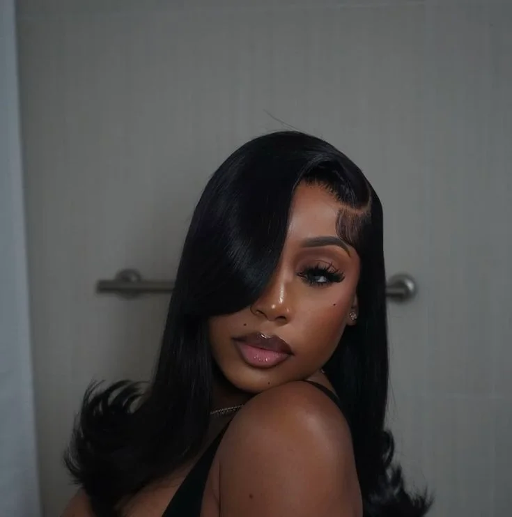 shoulder wavy black layers shown as a hollywood waves idea, featuring side part