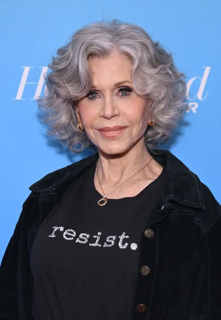 Curly gray layered bob with rounded volume on a woman over 60