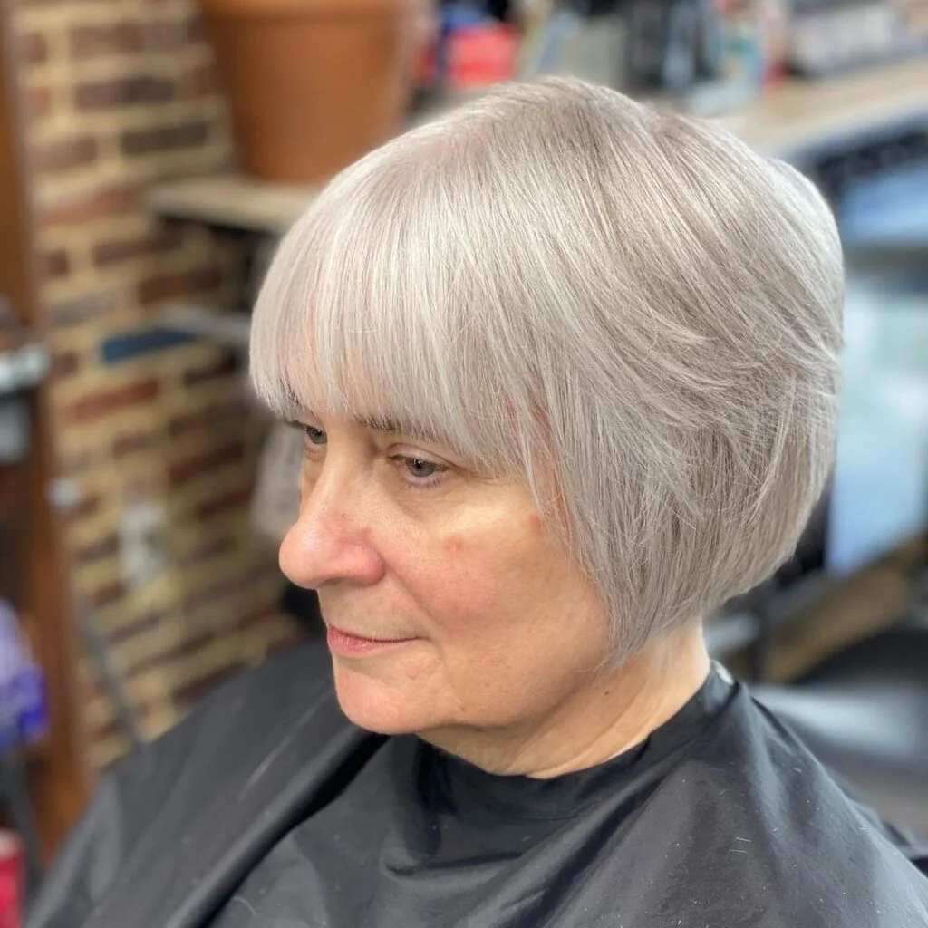 Short gray layered bob with crown lift and a rounded side shape