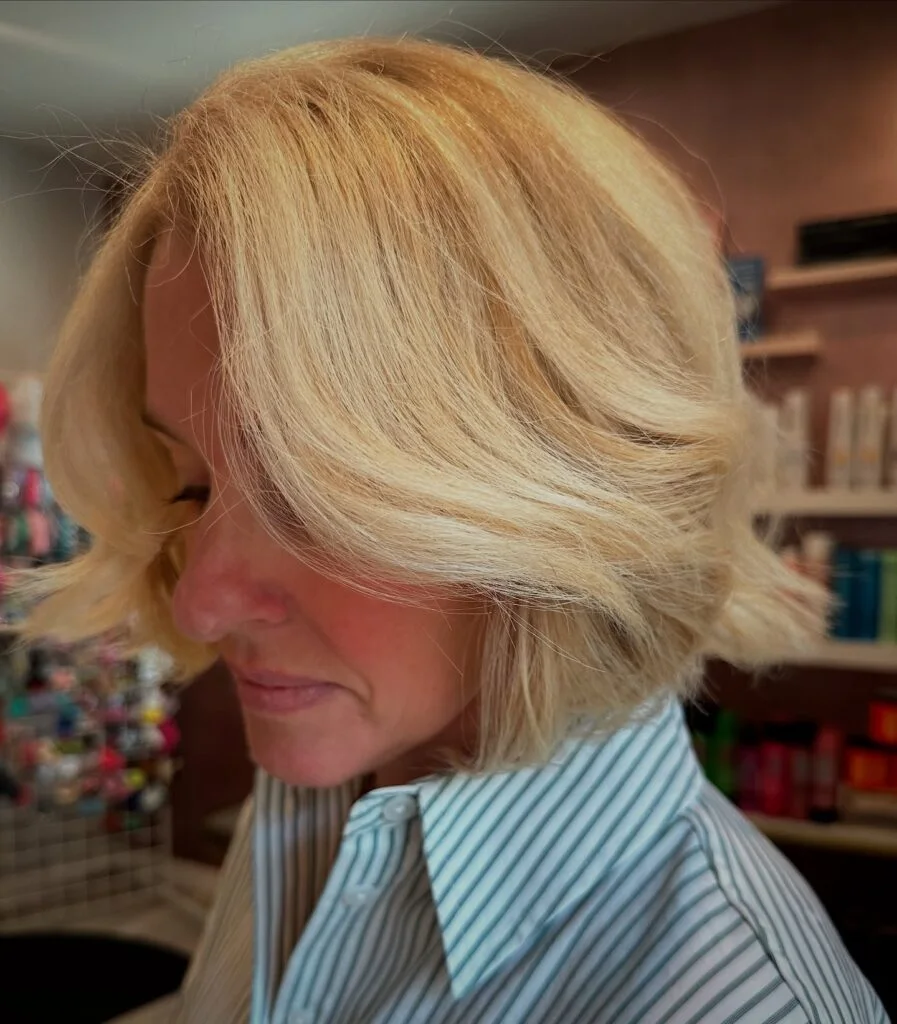 chin straight blonde bob with side swept fringe shown as a layered bob haircuts for women over 60 idea