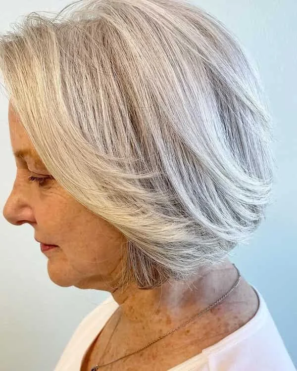 Side view blonde layered bob with feathered back movement