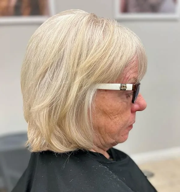 Blonde layered bob with glasses and a softly rounded shape