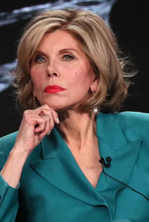 Polished blonde layered bob with rounded volume on an older woman