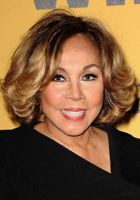 Warm rounded layered bob with soft face framing on an older woman