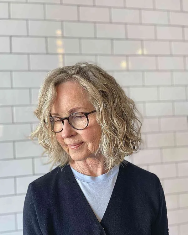 Older woman with glasses and a wavy layered bob