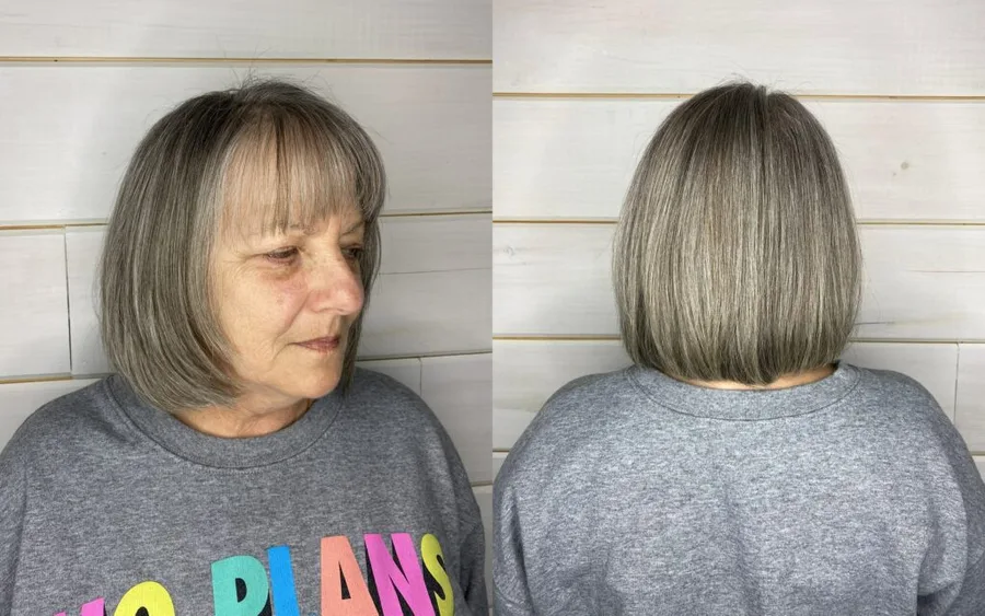 Older woman with a feathered gray bob and wispy bangs