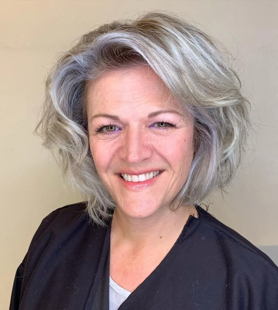 Older woman with a silver layered bob and lifted crown