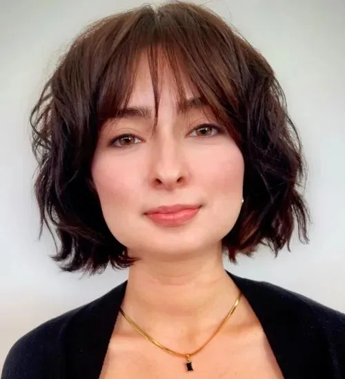 Piecey brunette bob with curtain bangs and short layered texture
