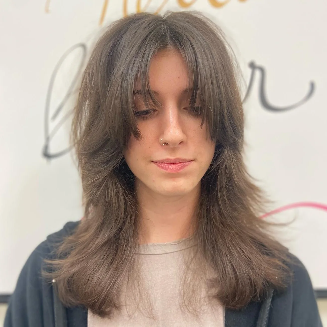 tousled curtain bang layers showing brunette long hair with curtain bangs and wavy texture
