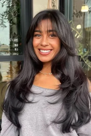 black wispy layered hair showing black long hair with wispy bangs and wavy texture