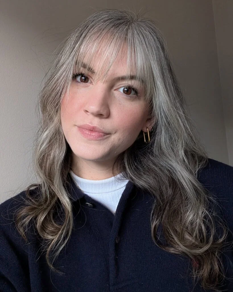 gray layers with soft wispy bangs showing gray long hair with wispy bangs and wavy texture
