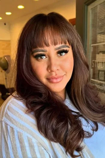 brunette blunt bangs with layers showing brunette long hair with blunt bangs and wavy texture