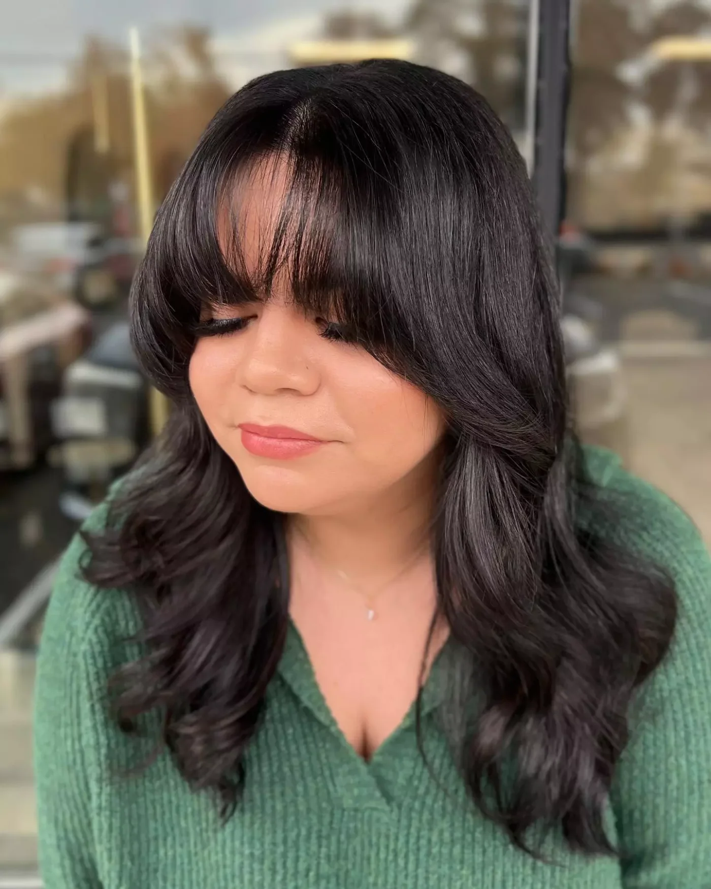 wavy black layers with full bangs showing black long hair with full bangs and wavy texture