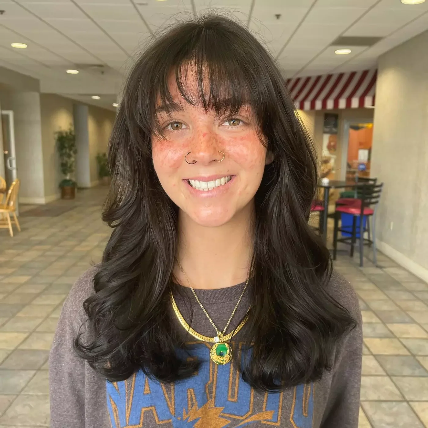 casual black layers with wispy bangs showing black long hair with wispy bangs and wavy texture