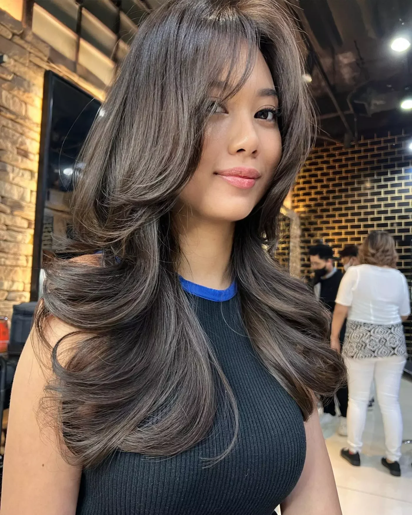 gray curtain layers showing gray long hair with curtain bangs and wavy texture