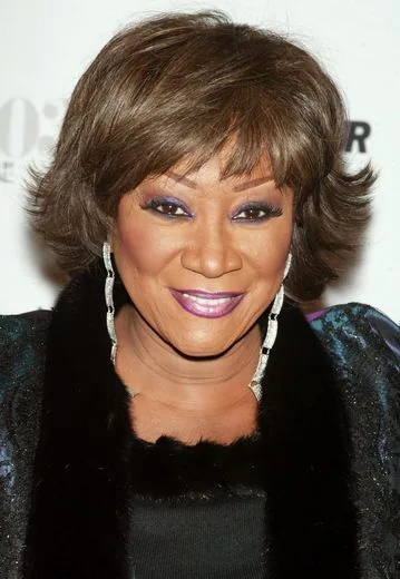 Older Black woman with a feathered short brunette bob and soft layered movement around the face