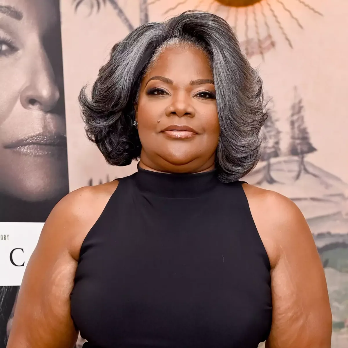 Older Black woman with a voluminous gray layered bob and soft rounded sides
